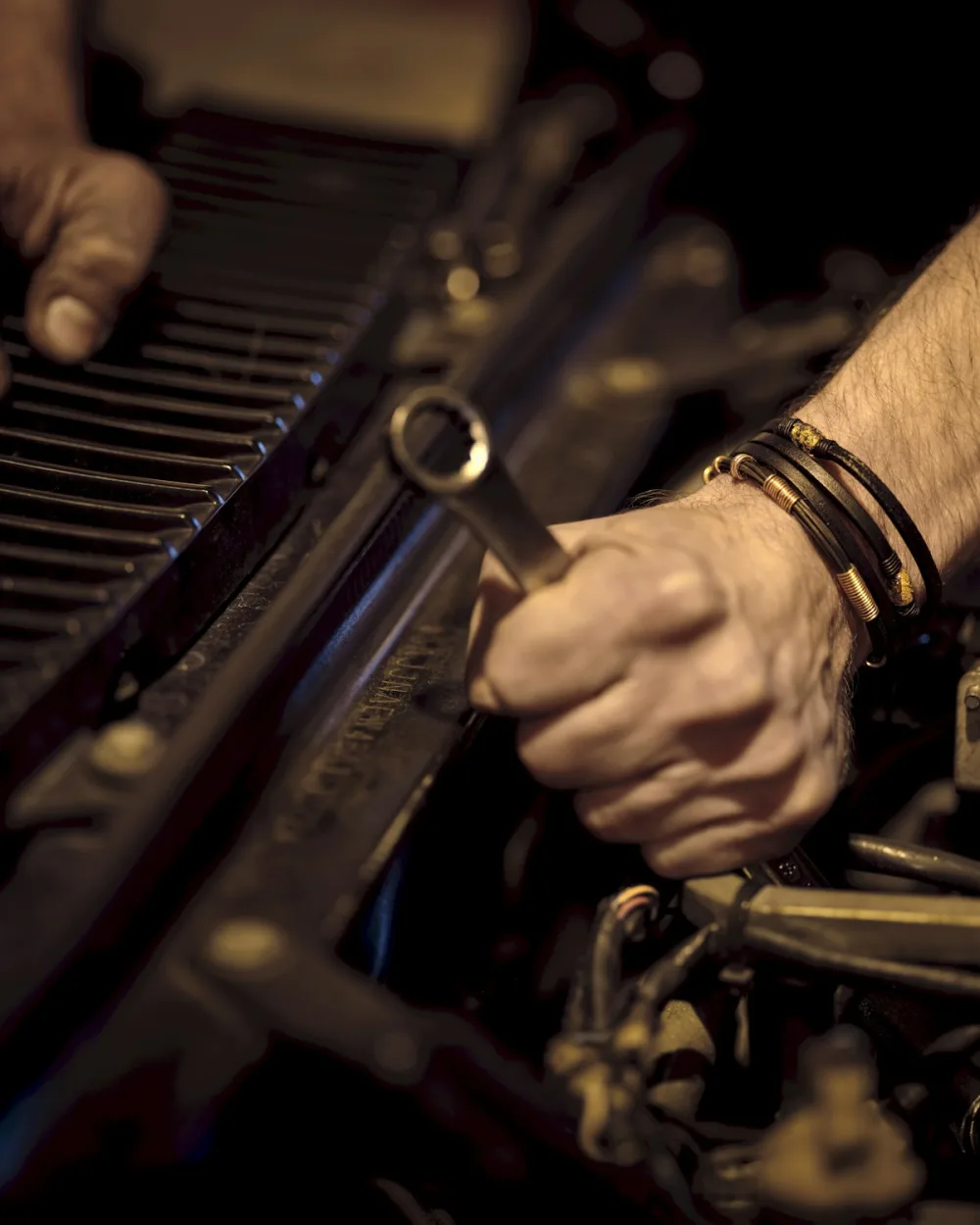 Auto mechanic working under a vehicle in a Chicago-area repair bay