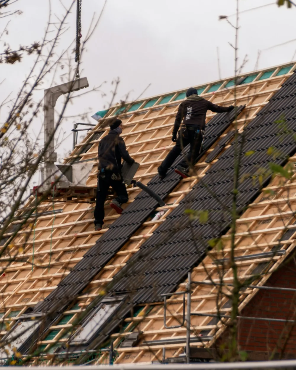 Roofing crew installing tiles on a South Florida house